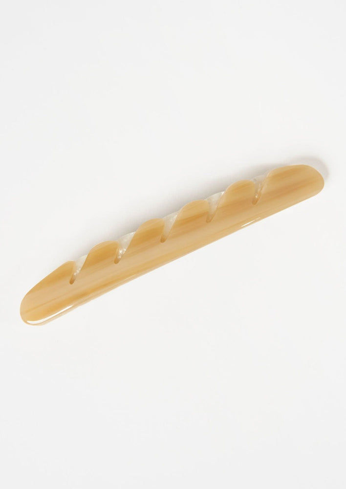 2: A baguette hair clip in light brown.