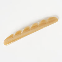 2: A baguette hair clip in light brown.