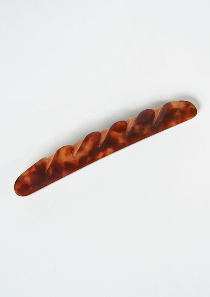3: A baguette hair clip in dark brown.