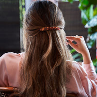 4: A woman wearing a baguette hair clip.