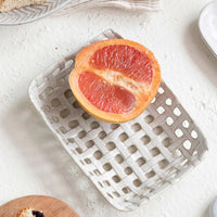 2: A rectangular shaped ceramic tray with open basketweave design.
