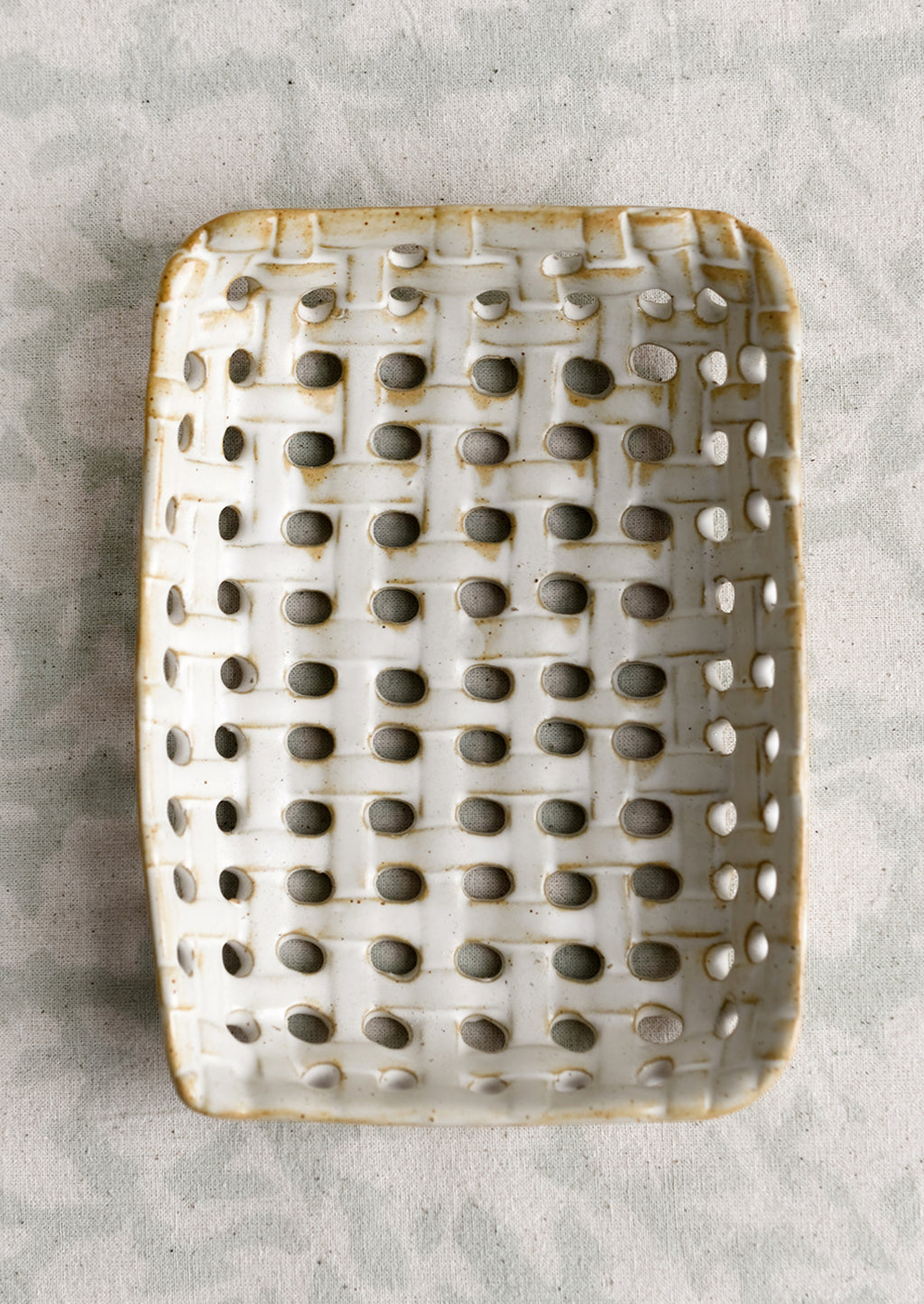 3: A rectangular shaped ceramic tray with open basketweave design.