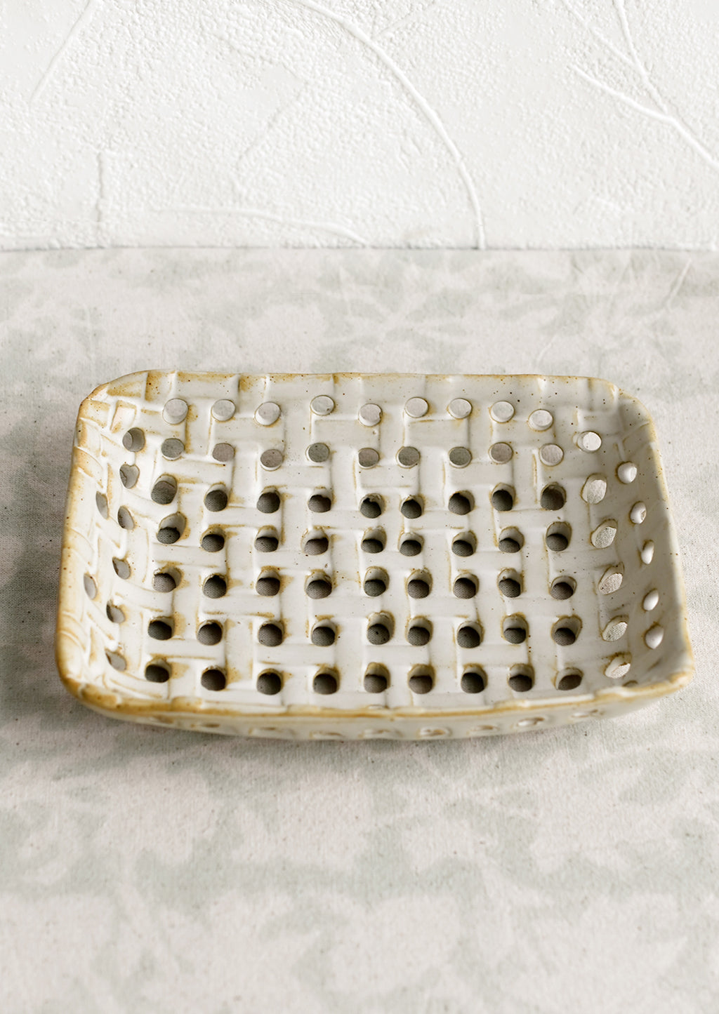 1: A rectangular shaped ceramic tray with open basketweave design.