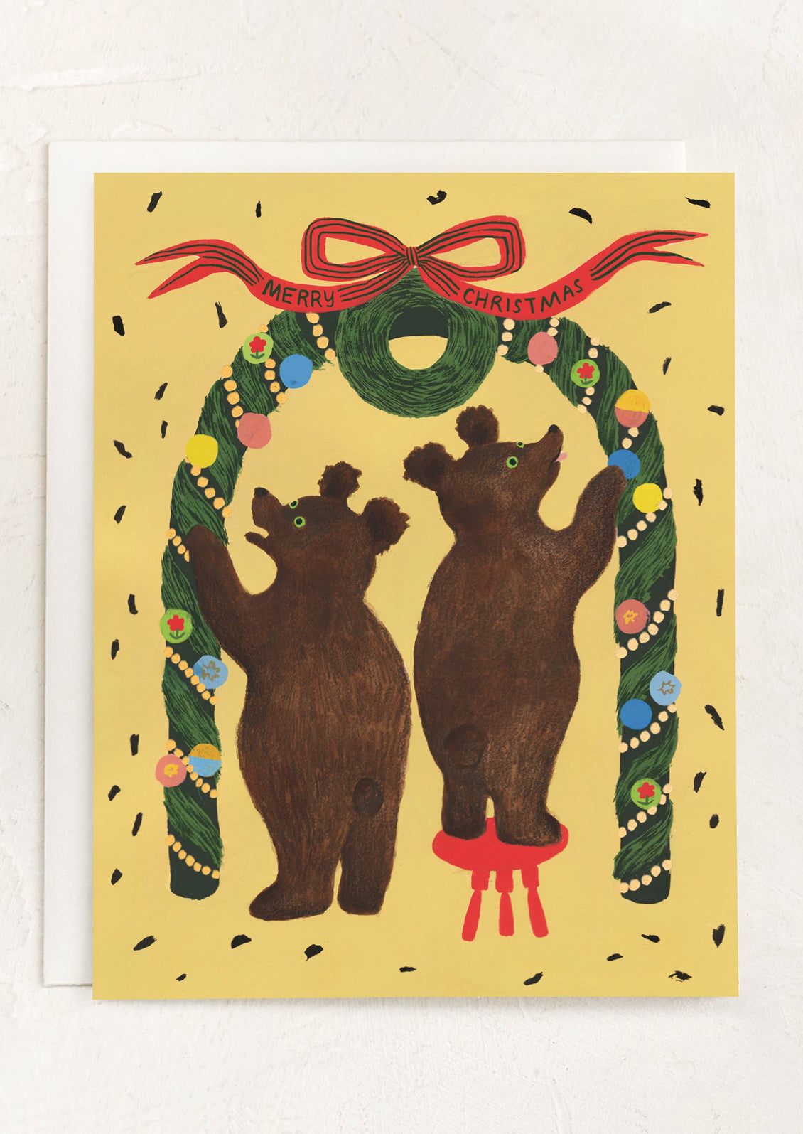 A greeting card with illustration of bears decorating an archway, banner reads "Merry Christmas".