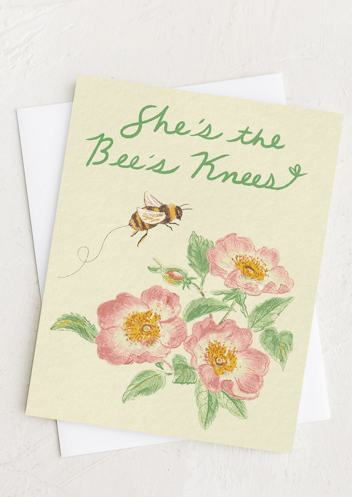 1: A greeting card with floral print reading "She's the bee's knees".