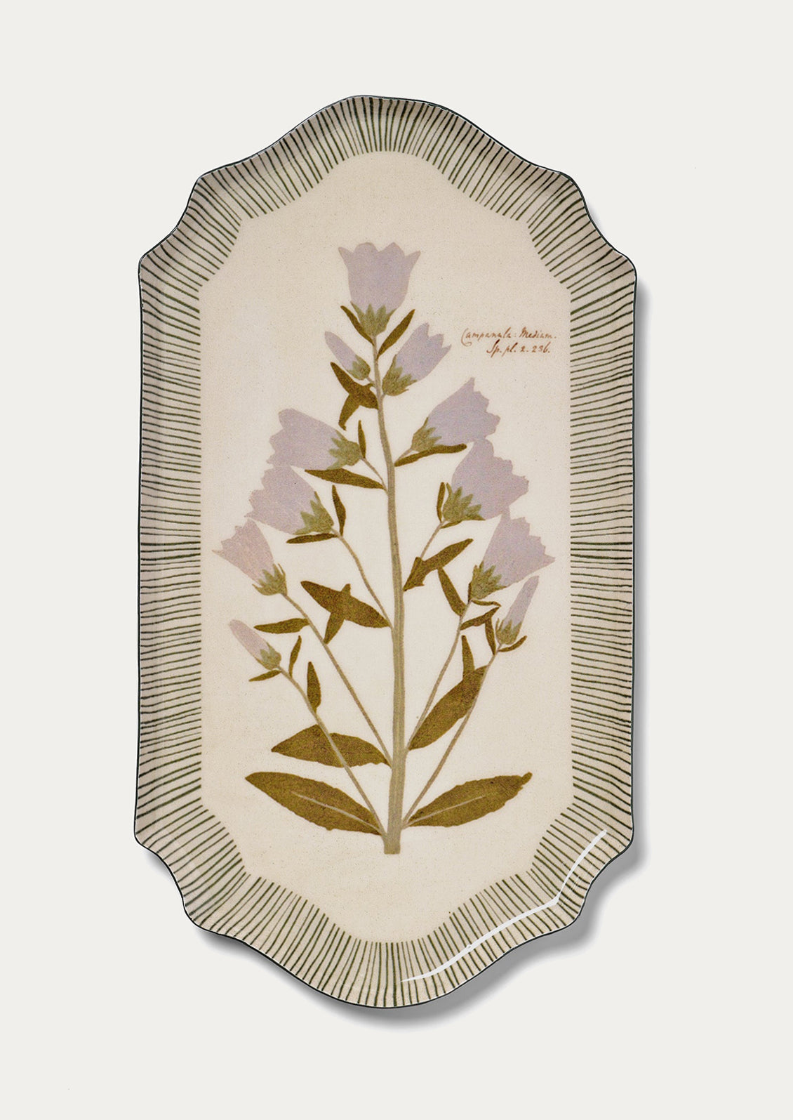 Decorative tray with floral design and textured border on a light background