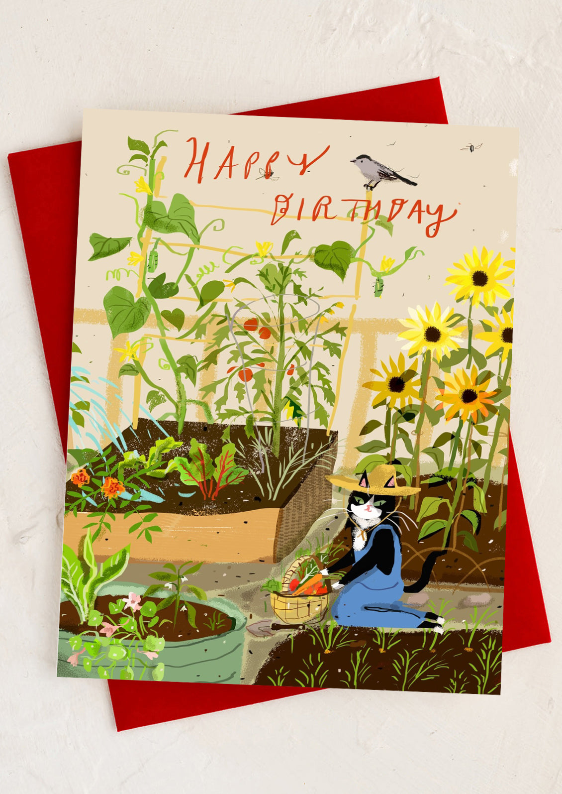 Birthday card with a garden scene and cat, featuring 'Happy Birthday' text.