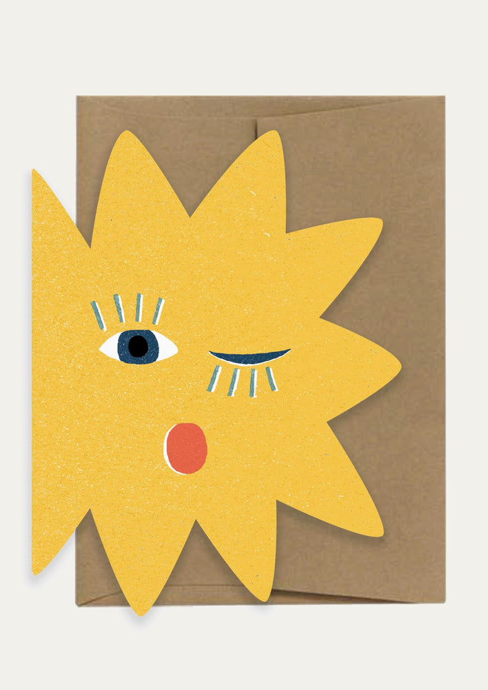 A diecut sun shaped card with blinking face.