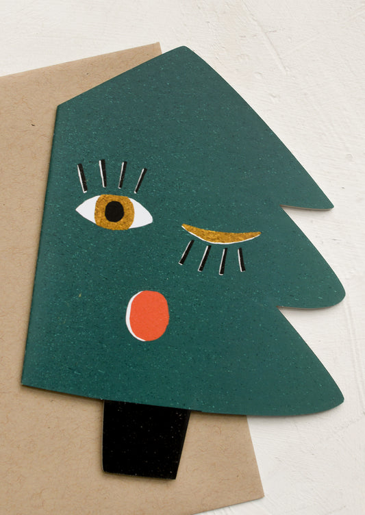 A diecut card in shape of a christmas tree with blinking face.