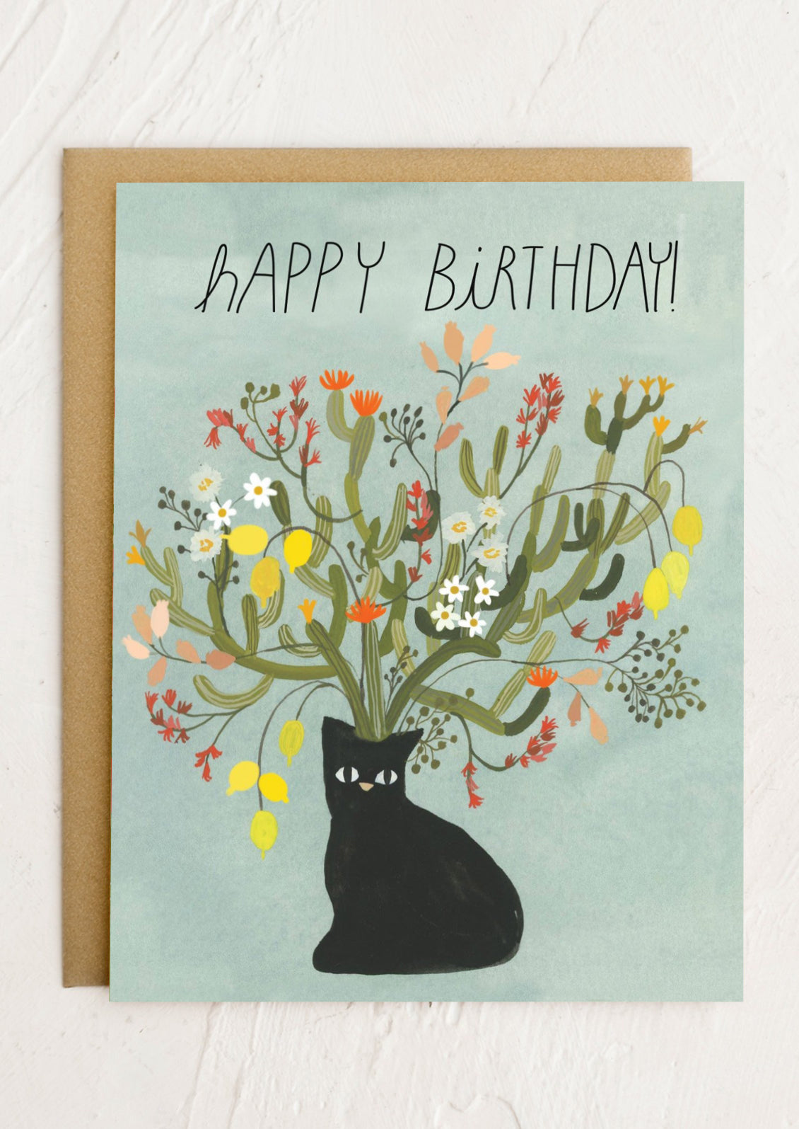 Birthday card with a black cat and floral design on a light blue background
