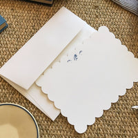 Blue Floral: A scalloped white notecard with blue flower and white envelope.