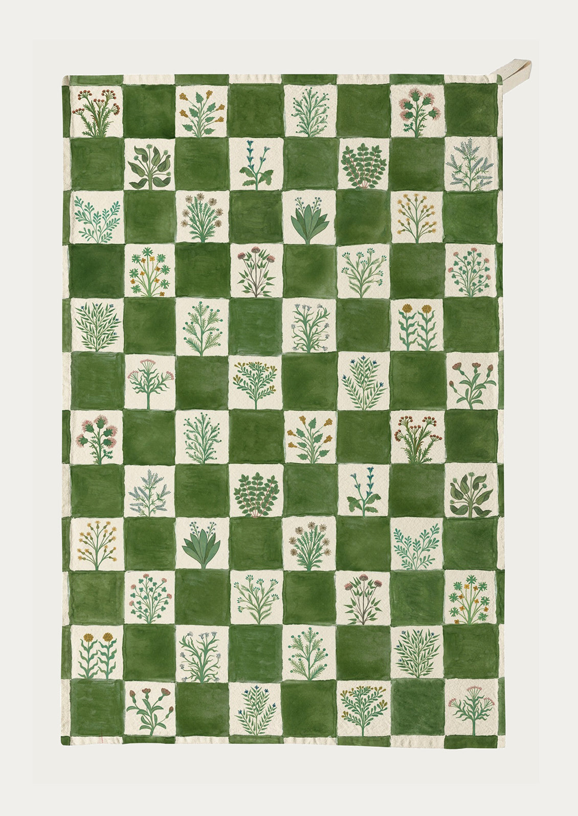 Green and white checkered towel with plant patterns on a white background
