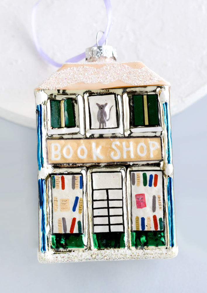 1: A glass holiday ornament of a book shop building.