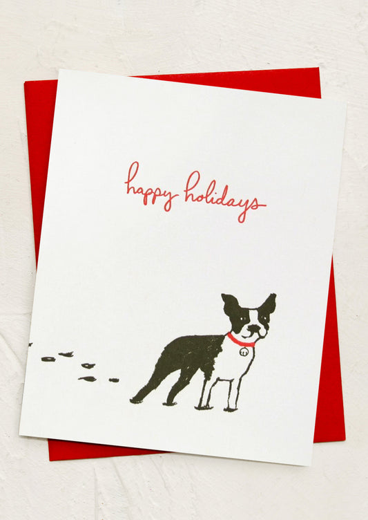 Greeting card with a dog illustration and 'happy holidays' text on a red envelope.