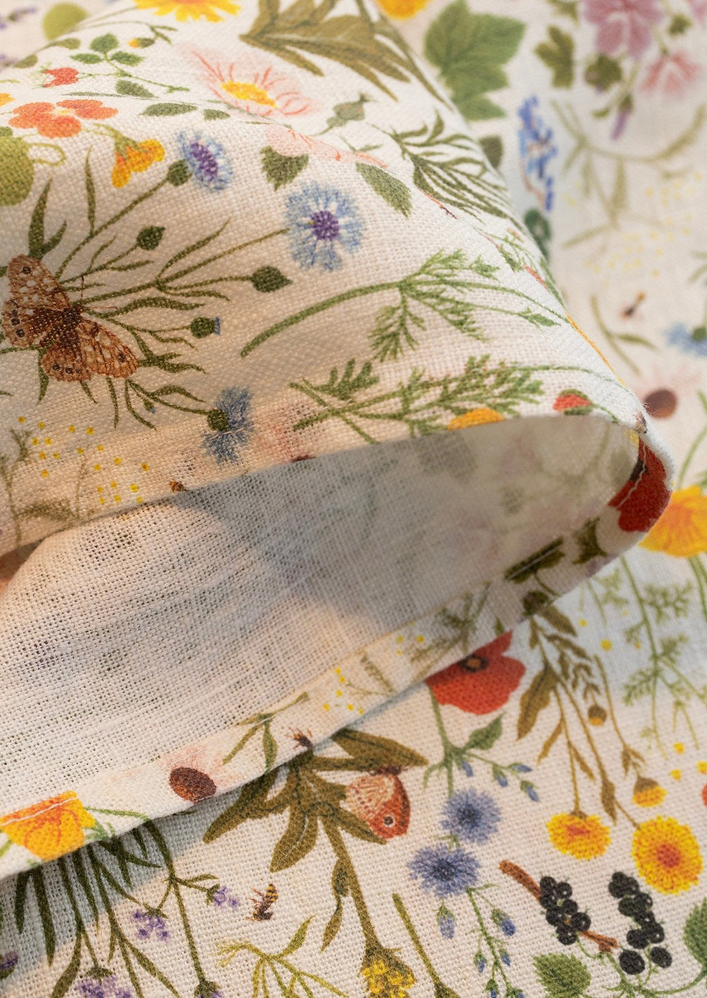 3: A linen tea towel with multicolor floral/botanical print.