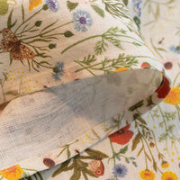 3: A linen tea towel with multicolor floral/botanical print.
