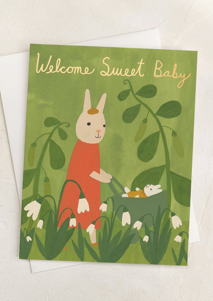 A card with illustration of mom and baby bunny, text reads "Welcome sweet baby".