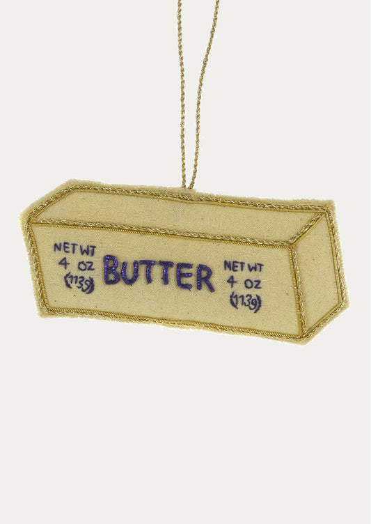 A decorative ornament made from fabric, depicting a stick of butter.