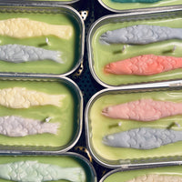 2: Multicolor tin of sardine candles.