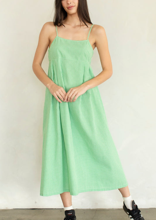 A person wearing a calf-length dress in micro green gingham.