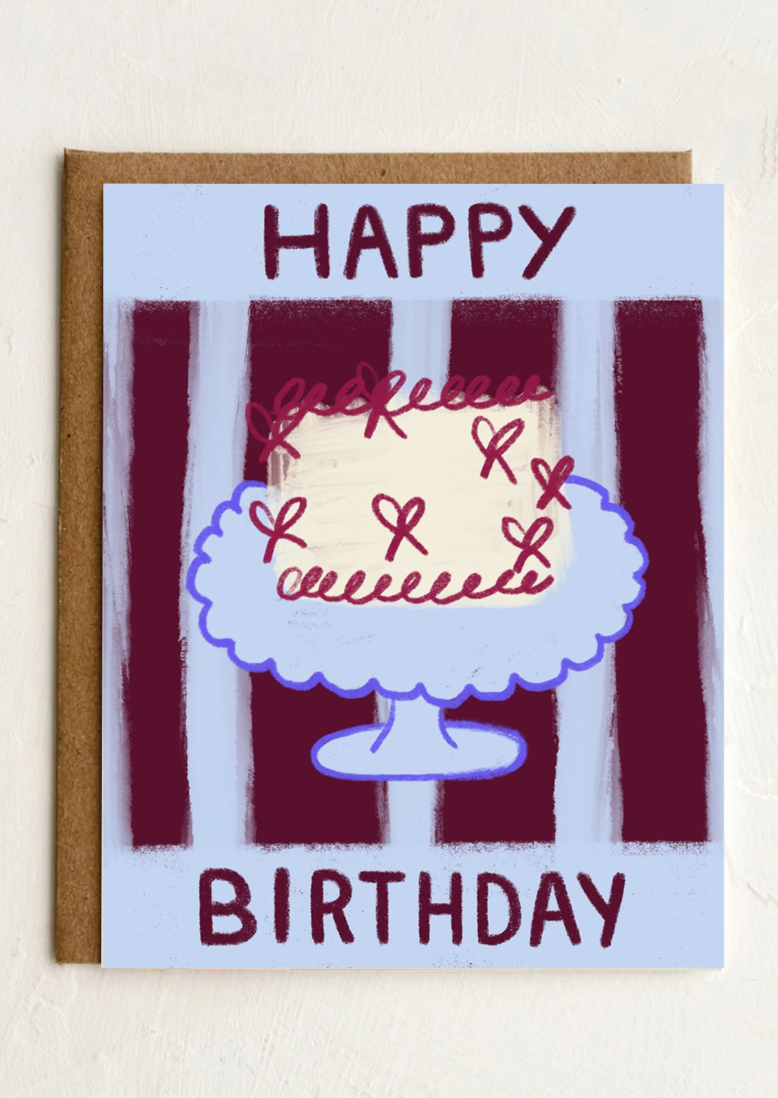 A greeting card with illustration of a birthday cake, text reads "Happy Birthday".