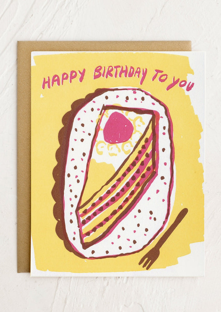 A birthday card with illustration of slice of cake on plate with fork.