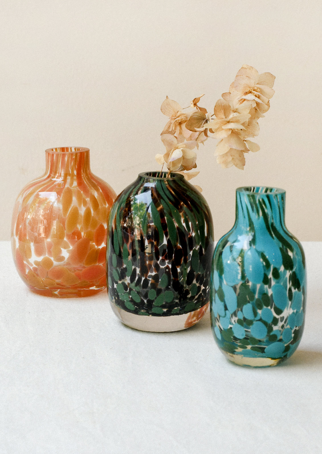 Small glass bud vases with a colorful painted design.