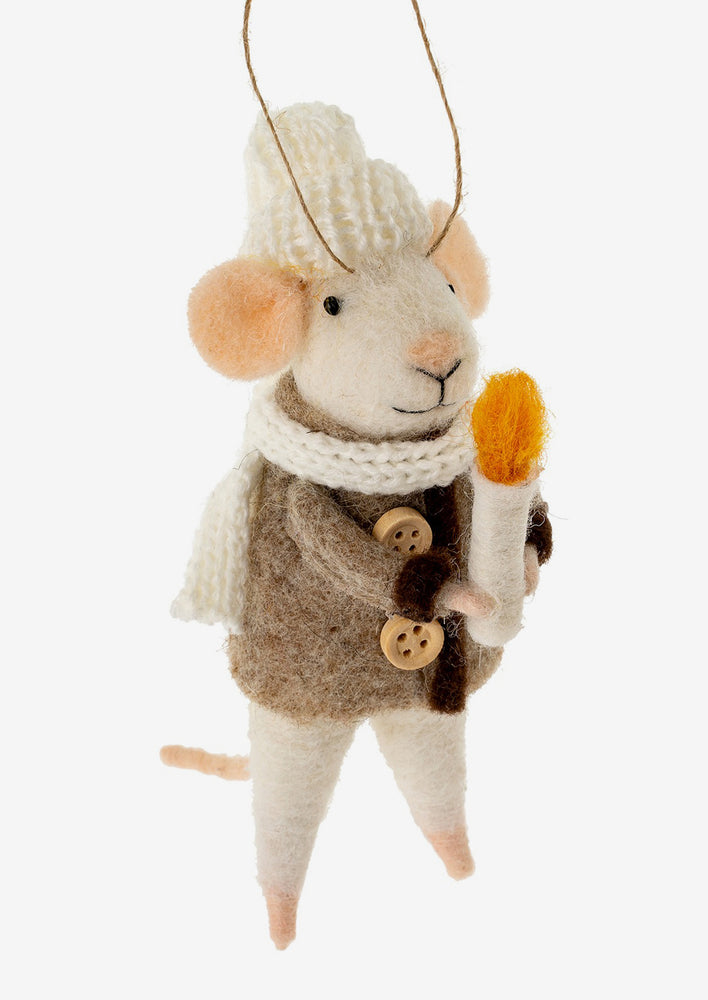A felted mouse ornament wearing a sweater and holding a candle.