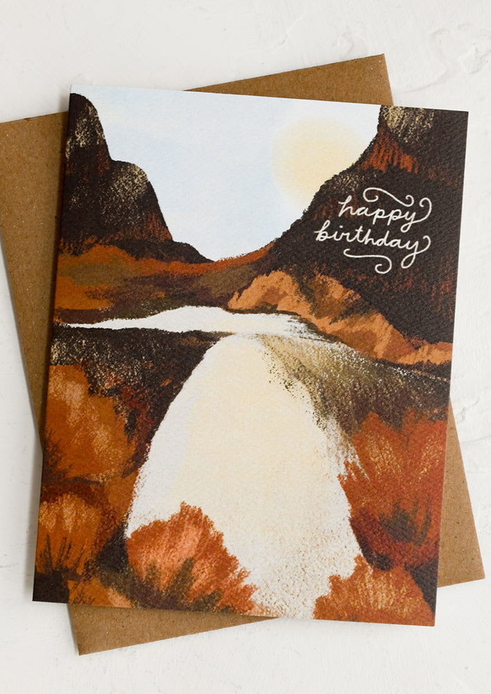 A birthday card with canyon and river illustration.