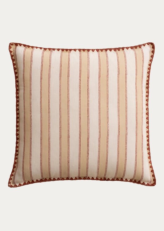 A square decorative throw pillow with vertical stripes in cream, beige, and rust brown, finished with a matching rust brown scalloped edge.