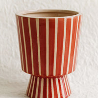 Small [$36.00]: A footed planter with vertical white stripes on red ceramic.