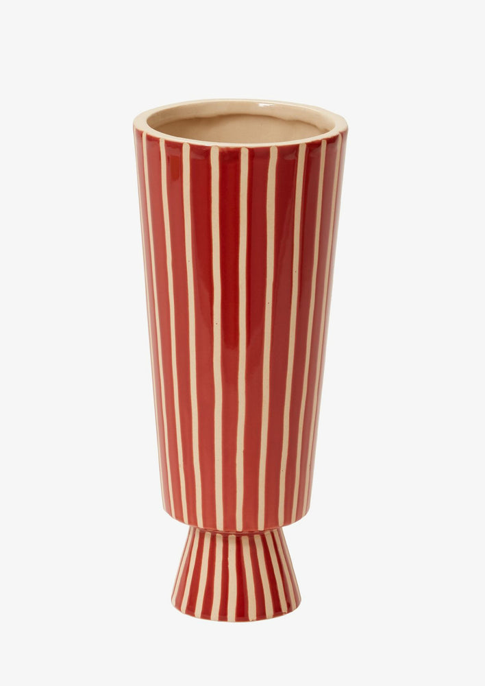 1: A tall and skinny vase with conical shape in red ceramic with vertical thin white stripes.