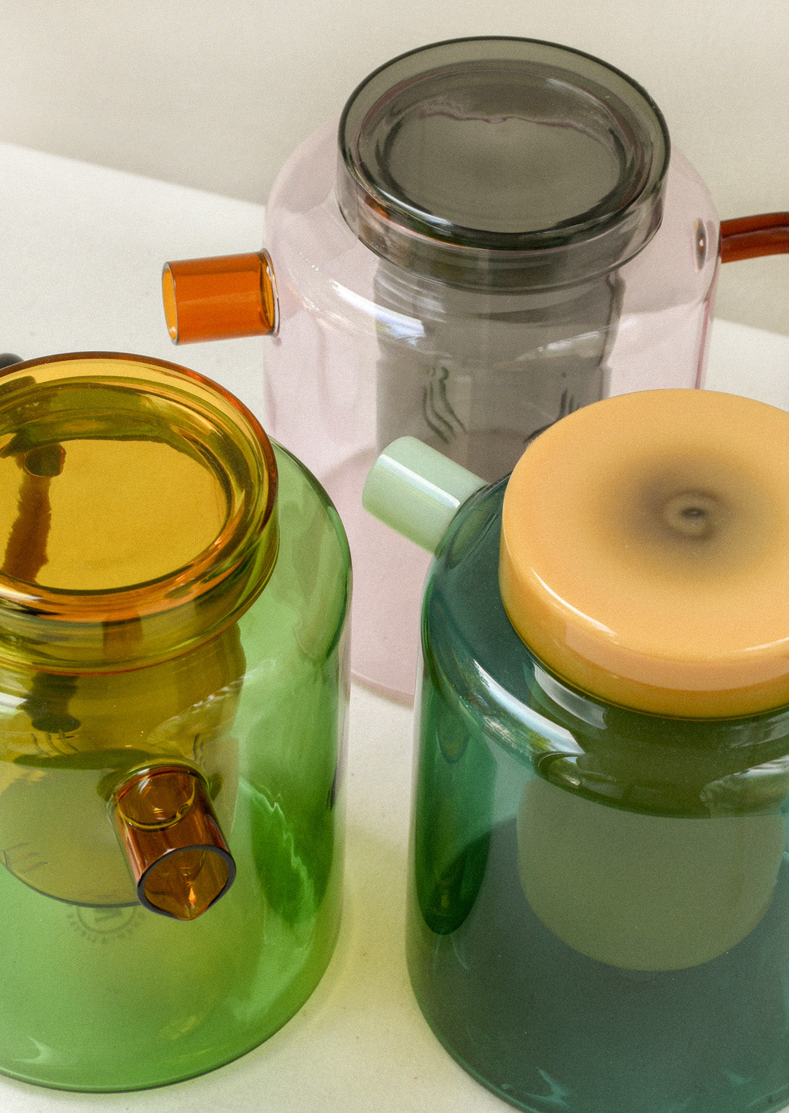 Multicolored glass teapots with removable tea steepers.