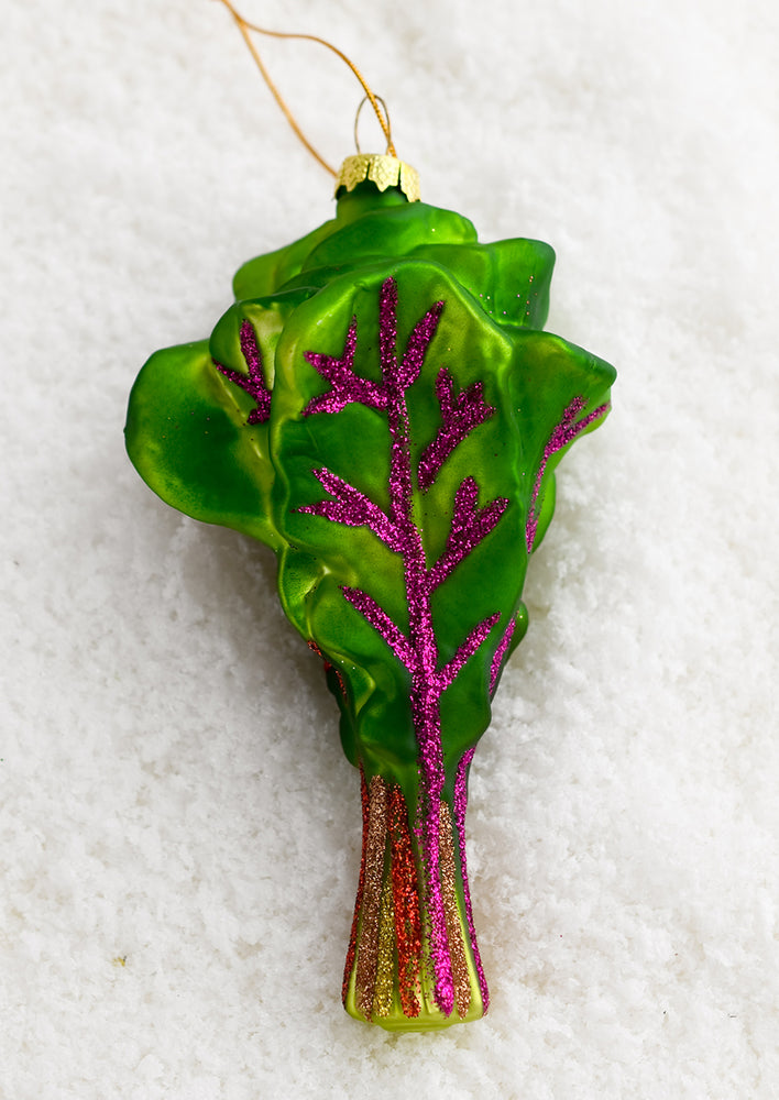 A glass ornament made to look like a bunch of rainbow chard.