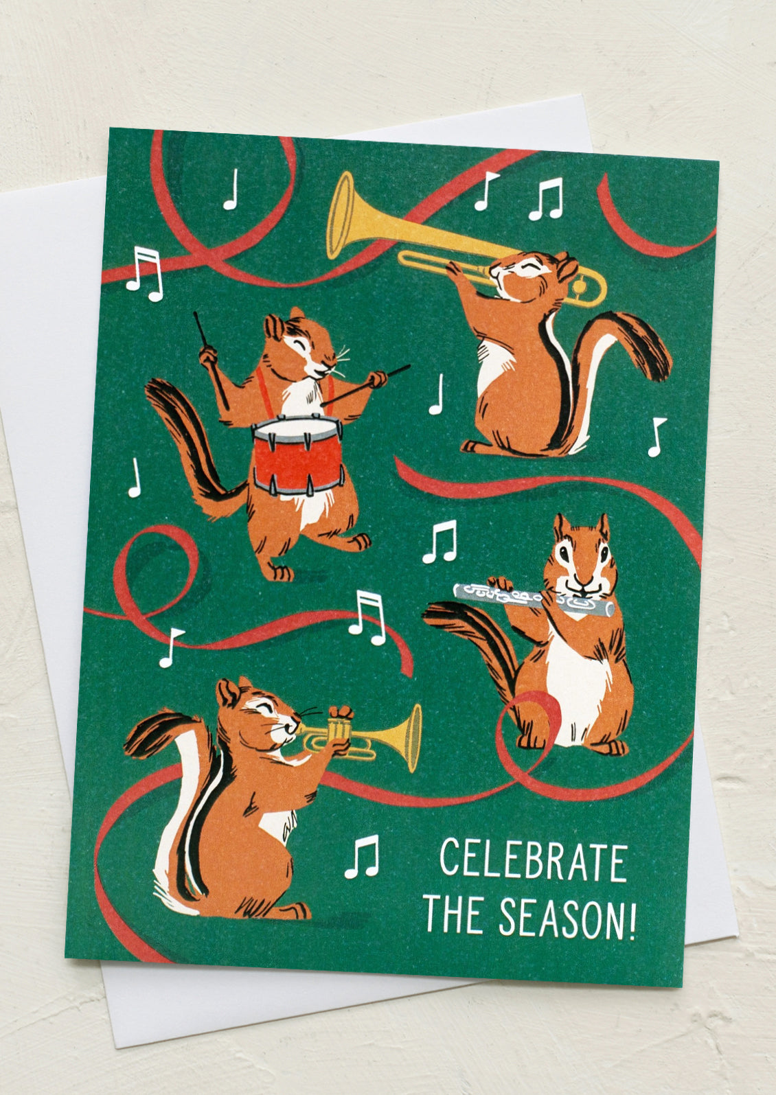 A set of green greeting cards with illustration of chipmunks playing musical instruments, text reads "Celebrate the season".