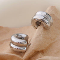 3: A pair of chunky rib textured hoop earrings in silver.