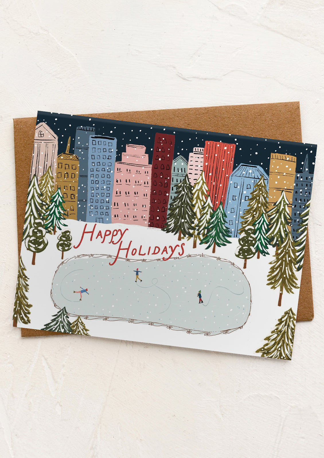 Holiday card with cityscape and snowy scene, featuring 'Happy Holidays' text.