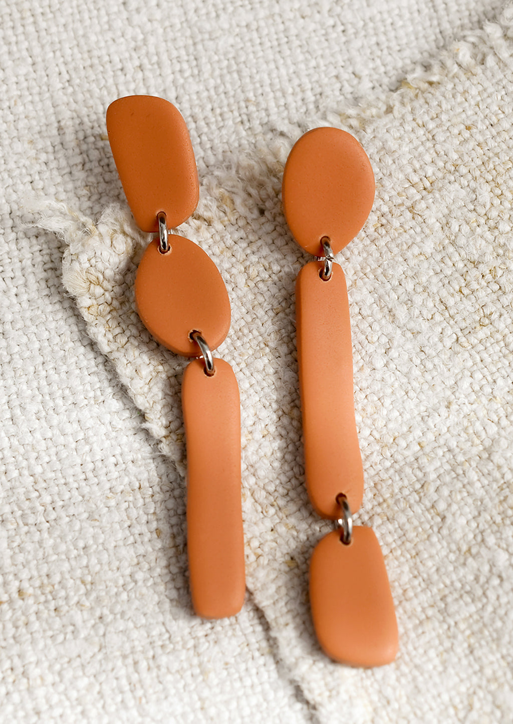 Tuscan Terracotta: A pair of clay earrings in post back drop silhouette.