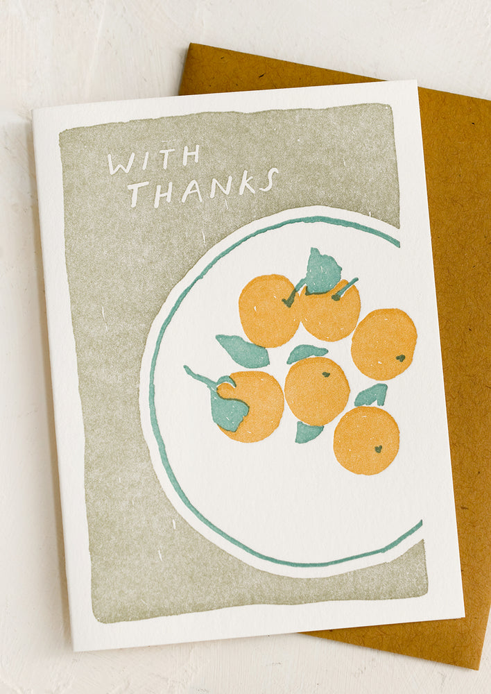 A thank you card with letterpressed image of oranges on a plate.