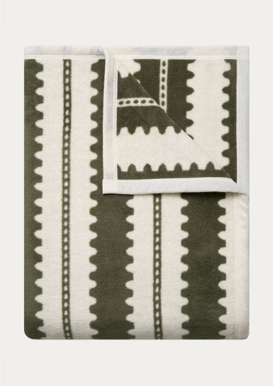 Folded blanket with olive green geometric stripe pattern.