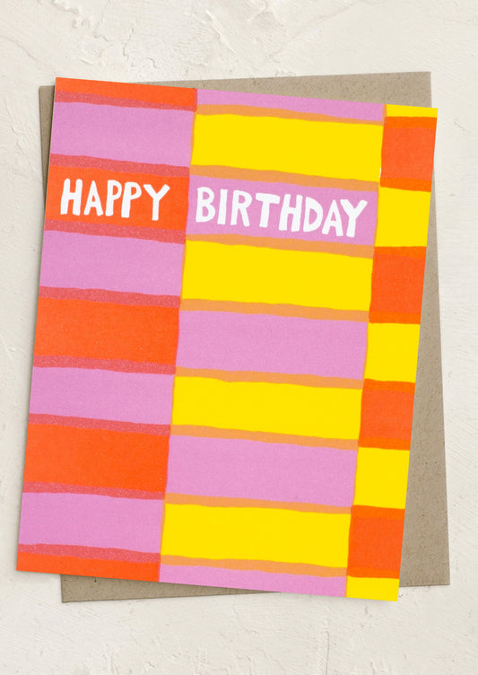 Colorful birthday card with 'Happy Birthday' text on a textured surface