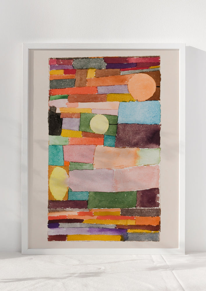 2: An art print of colorful abstract shapes stacked together, in white frame.