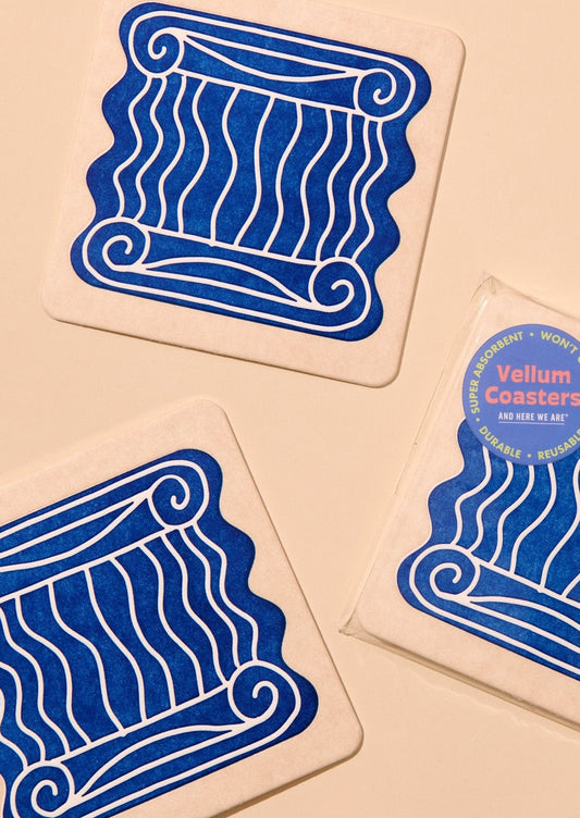 Set of three coasters with blue decorative design on beige background