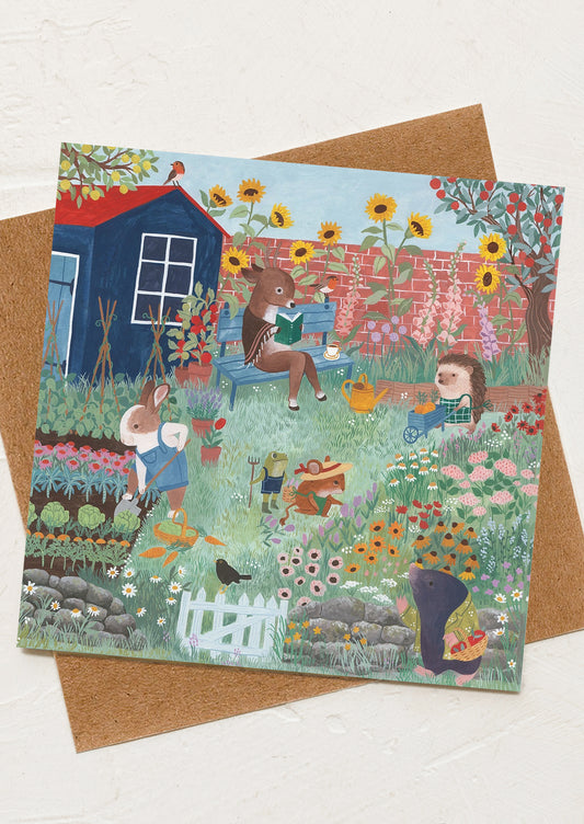 Greeting card with a colorful illustration of animals in a garden on a brown envelope.