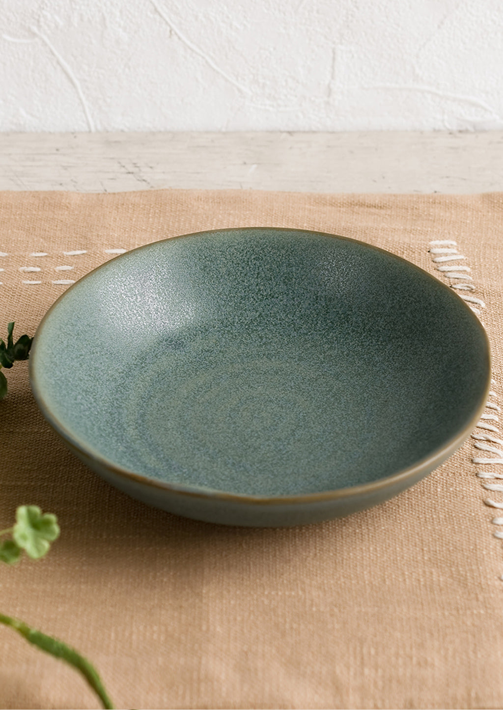 1: A mossy green-blue shallow ceramic bowl.