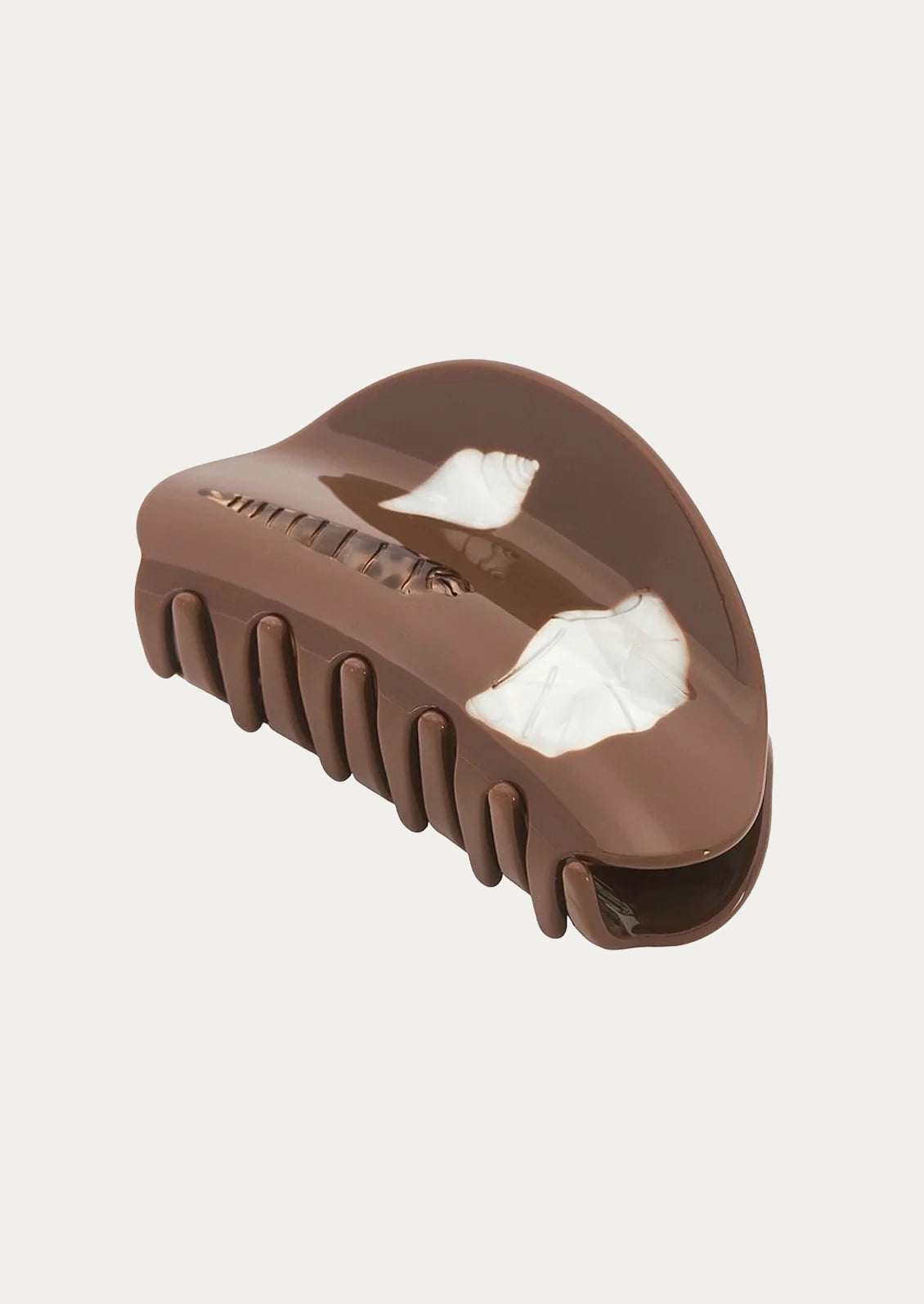 A brown hair clip adorned with seashells.