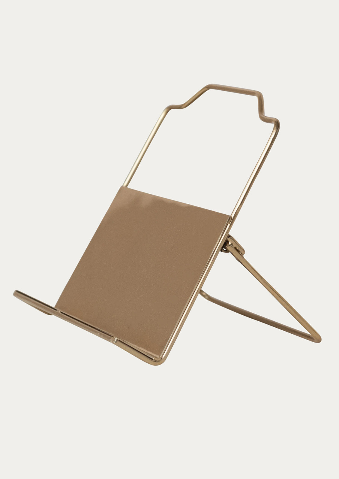 A folding book stand in gold-tone metal.