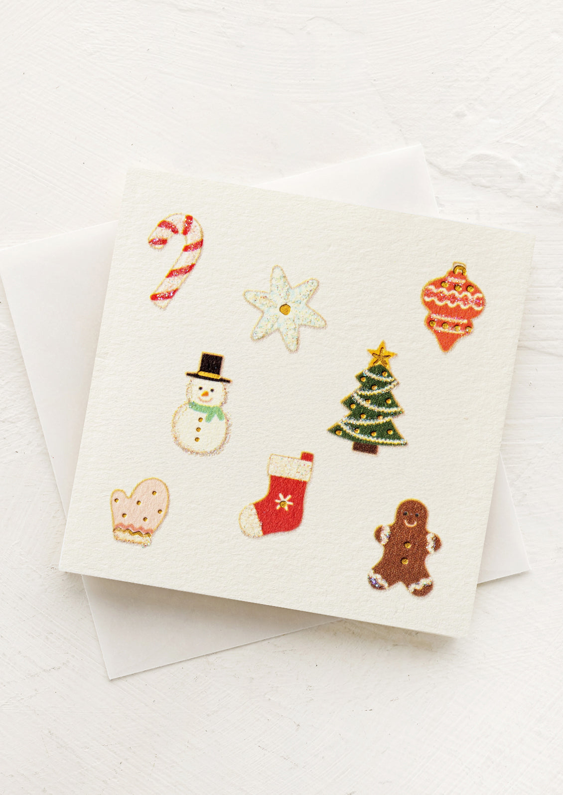 Set of Christmas-themed icons on a white card with an envelope.