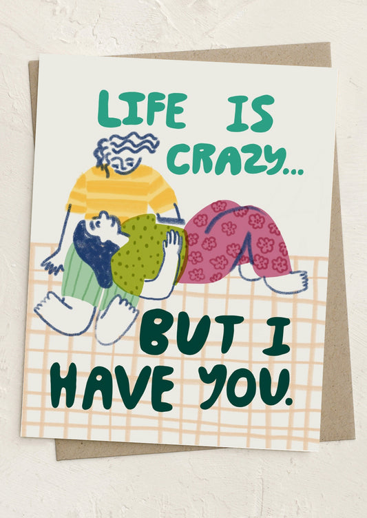 Card with illustration of two people hugging and text 'Life is crazy... but I have you.'