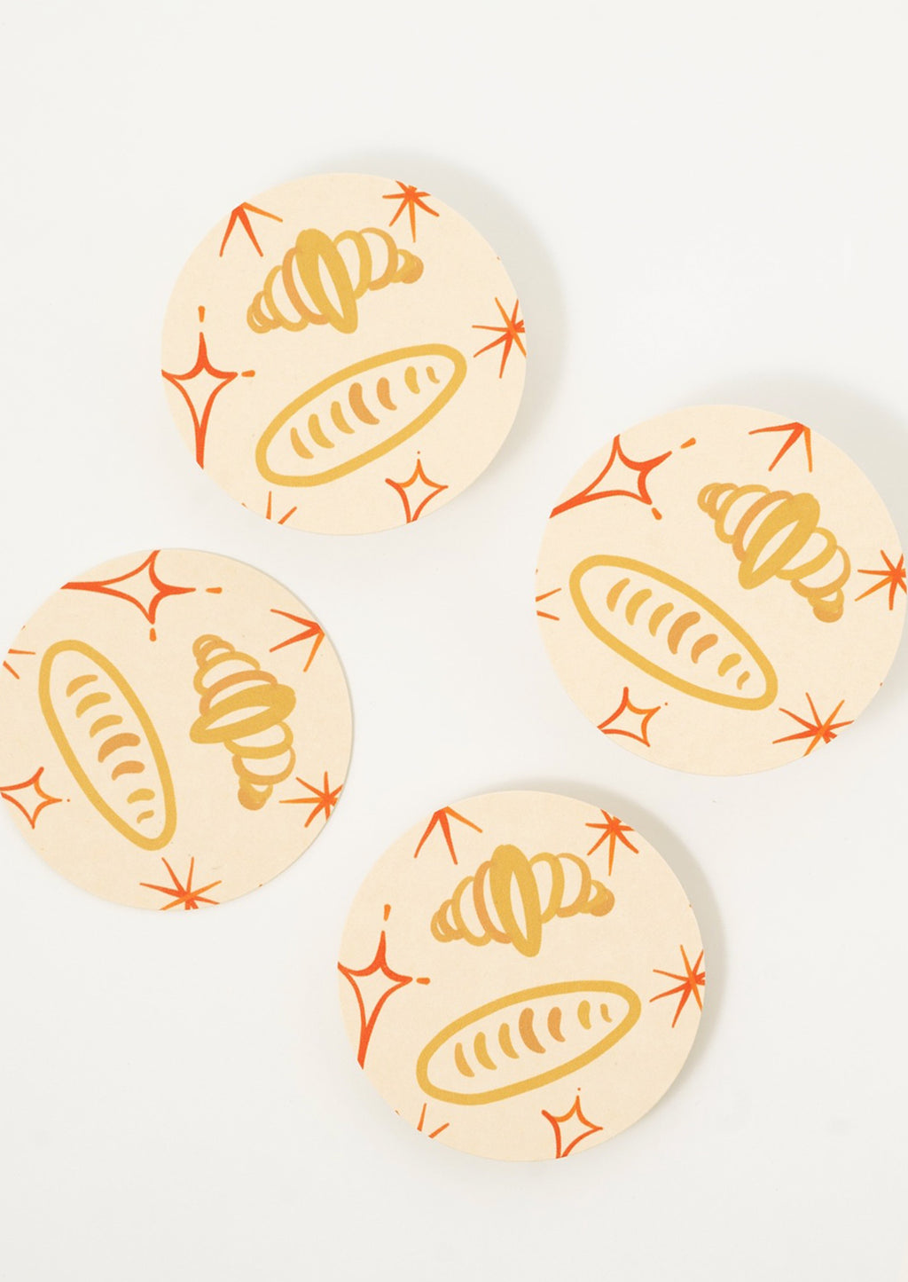 Croissants: Paper coasters with bread and croissant print.